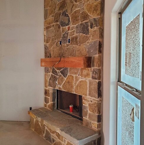 Interior floor-to-ceiling stone fireplace